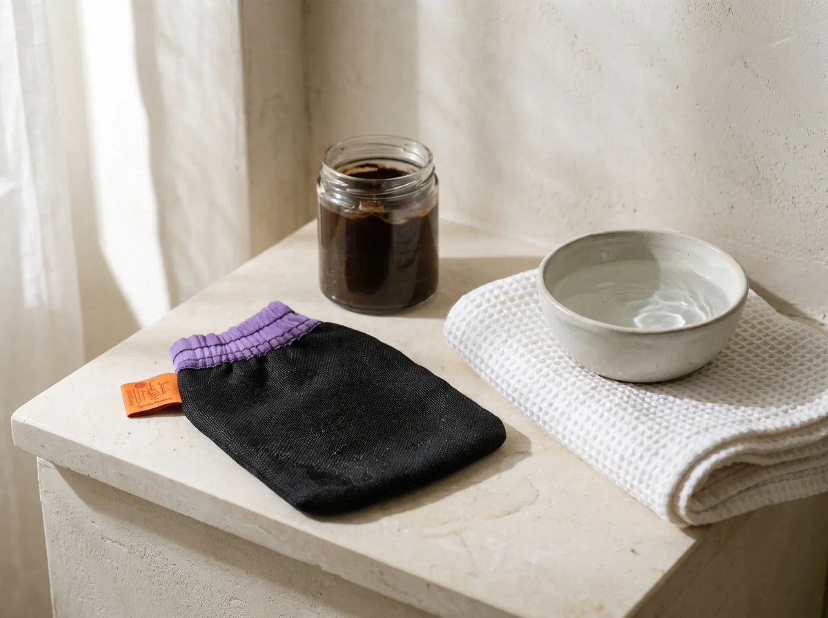 Gant kessa Zayyan posé à plat et humide sur une tablette de salle de bain, serviette blanche à côté